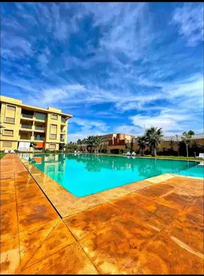 a large swimming pool in front of a building at Marrakech Luxury ATLAS in Marrakech
