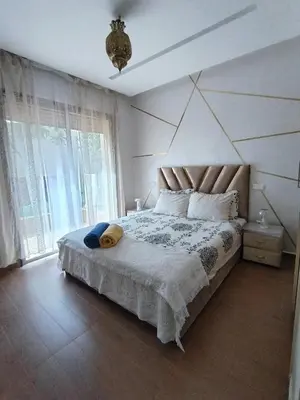 a bedroom with a large bed with a large window at Marrakech Luxury ATLAS in Marrakech
