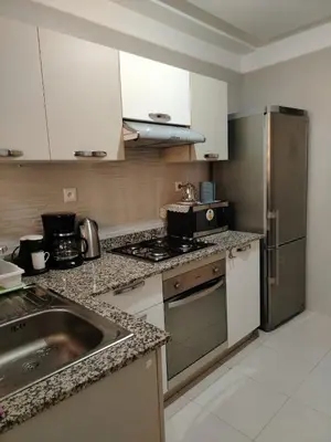 a kitchen with a sink and a stove top oven at Marrakech Luxury ATLAS in Marrakech
