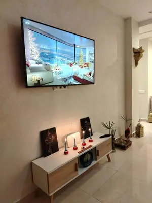 a living room with a flat screen tv on the wall at Marrakech Luxury ATLAS in Marrakech