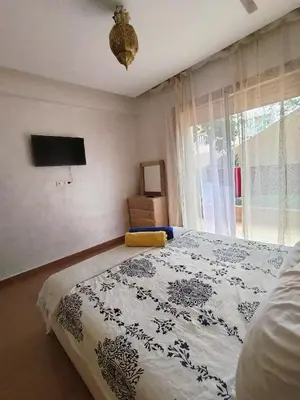 a bedroom with a large bed and a window at Marrakech Luxury ATLAS in Marrakech