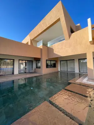 a building with a swimming pool in front of it at Les Villas de Marrakech in Marrakech