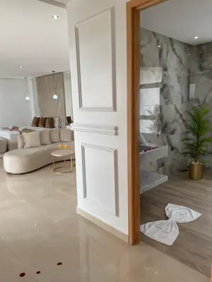 a living room with a white door and a couch at Les Villas de Marrakech in Marrakech
