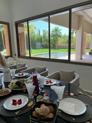a dining room table with plates of food on it at Les Villas de Marrakech in Marrakech