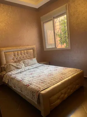 a bed in a bedroom with a window at Garden View in Marrakech