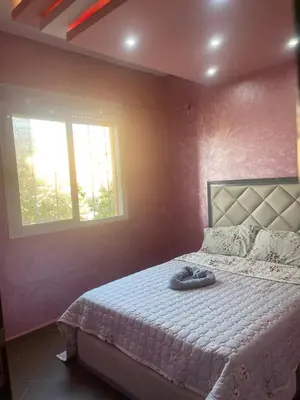a bedroom with a large bed in a room with a window at Garden View in Marrakech