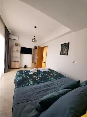a bedroom with a large bed in a room at Wonderful apartment pool residence Babylon in Marrakech