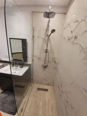 a bathroom with a shower and a sink at Wonderful apartment pool residence Babylon in Marrakech