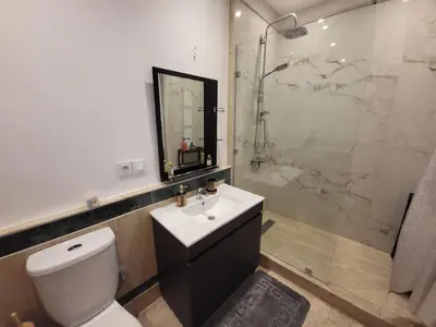 a bathroom with a toilet and a sink and a shower at Wonderful apartment pool residence Babylon in Marrakech