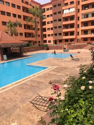 an empty swimming pool in a building with buildings at Wonderful apartment pool residence Babylon in Marrakech