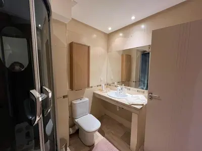 a small bathroom with a toilet and a sink at Appartement idyllique au centre ville in Marrakech