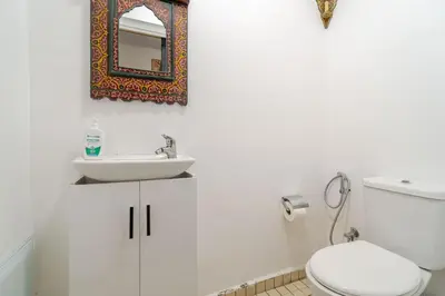 a bathroom with a sink and a toilet and a mirror at Villa Slimani in Marrakech