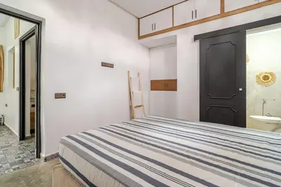 a bedroom with a bed and a black door at Villa Slimani in Marrakech