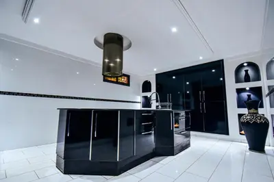a kitchen with a black island in a room at holiday villa in marrakech in Marrakech