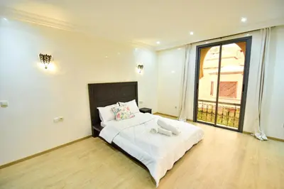 a bedroom with a bed and a large window at holiday villa in marrakech in Marrakech