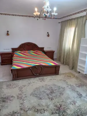 a bedroom with a bed with a colorful blanket on it at Appartement in Marrakech