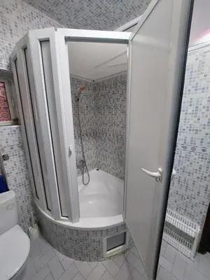 a bathroom with a shower with a tub and a toilet at Appartement in Marrakech