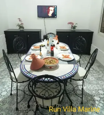 a table with plates of food on it at Elegant Marrakech Villa with Optional Heated Pool for Ultimate Relaxation in Touggana