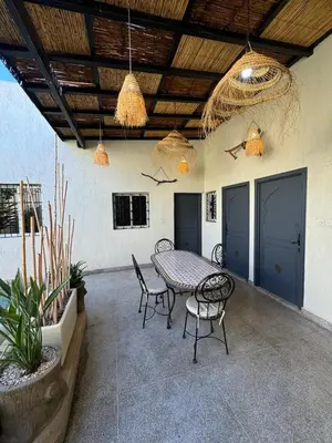 a patio with a table and chairs and lights at Elegant Marrakech Villa with Optional Heated Pool for Ultimate Relaxation in Touggana