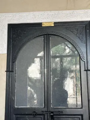 a black door with a sign on top of it at Run Villa Marine, Elegant Private Villa in Marrakech with Heated Pool Option in Marrakech