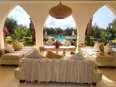 a living room with couches and a pool at Palais Debora in Marrakech