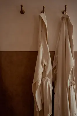 a white wedding dress hanging on a wall at Riad Berbère Marrakech in Marrakech