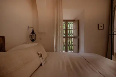a bedroom with two beds and a window at Riad Berbère Marrakech in Marrakech