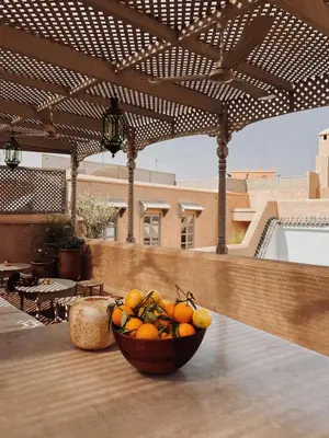 a bowl of fruit sitting on a table on a patio at Riad Berbère Marrakech in Marrakech
