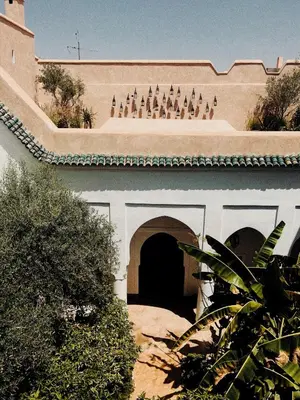 a building with an arch with statues on it at Riad Berbère Marrakech in Marrakech