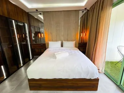 a bedroom with a large bed with white sheets at Hivernage appartement premium in Marrakech