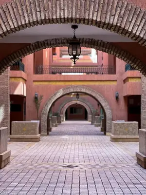 a brick hallway with an archway in a building at Hivernage appartement premium in Marrakech