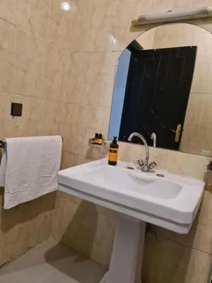 a bathroom with a white sink and a mirror at Hotel Appart HB in Marrakech