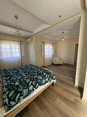 a bedroom with a large bed with a blanket on it at very nice house in Marrakech