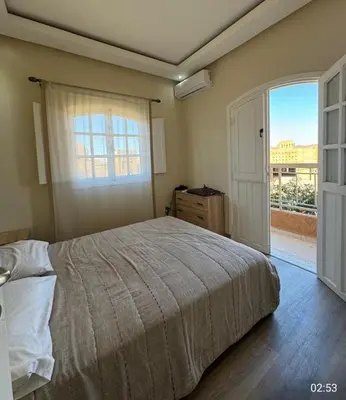 a bedroom with a bed and a large window at very nice house in Marrakech
