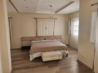 a bedroom with a bed and a large window at very nice house in Marrakech