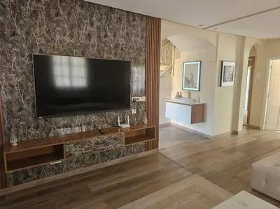 a living room with a flat screen tv on a wall at very nice house in Marrakech