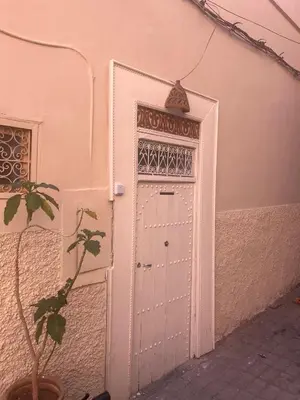 a white door in a building with a plant at Dar Babette in Marrakech