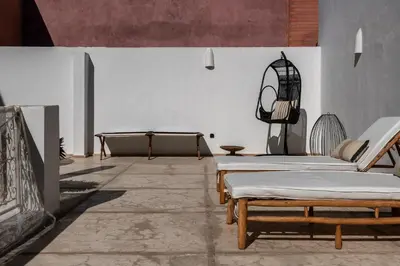 a room with two beds and a fireplace at Dar Babette in Marrakech