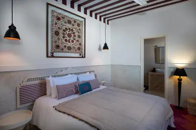 a bedroom with a large white bed with pillows at Dar Babette in Marrakech