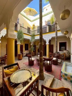 a large room with tables and chairs in a building at superbe riad en exclusivité B&B in Marrakech