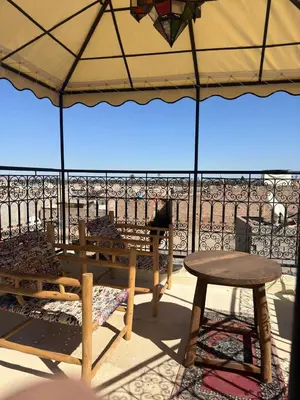 a picnic table and a table and an umbrella at superbe riad en exclusivité B&B in Marrakech