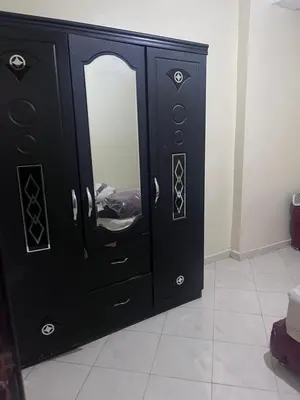 a black dresser with a mirror in a room at Yassmirouaq in Marrakech