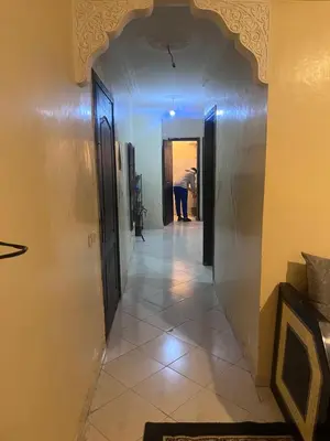 a hallway in a house with a person in the distance at Yassmirouaq in Marrakech