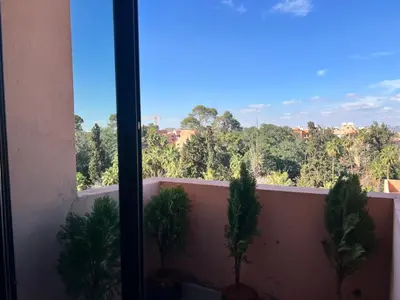 a view of trees from a balcony with plants at Appartement tout neuf à Gueliz Marrakech Plaza Zara in Marrakech