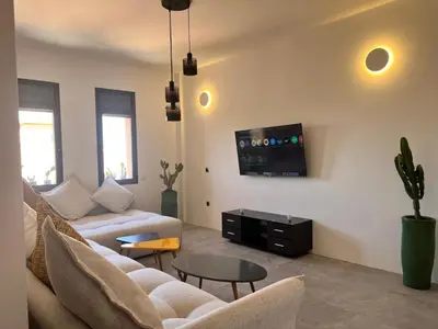 a living room with a couch and a table at Appartement tout neuf à Gueliz Marrakech Plaza Zara in Marrakech