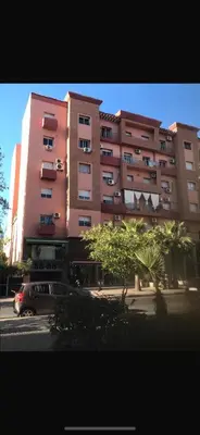 a pink building with a car parked in front of it at Appartement tout neuf à Gueliz Marrakech Plaza Zara in Marrakech