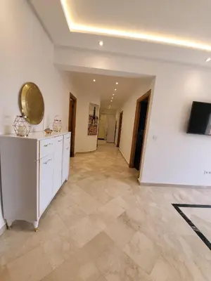 a large kitchen with white walls and tile floors at Wonderful apartment pool residence Babylon 2- chambre in Marrakech