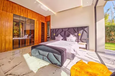 a bedroom with a large bed and a large window at Villa Beverly hills-luxury home in Marrakech