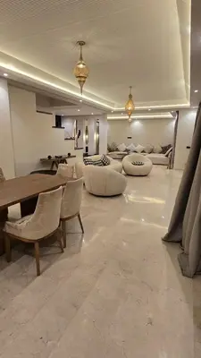a large living room with a table and chairs at bianca in Marrakech