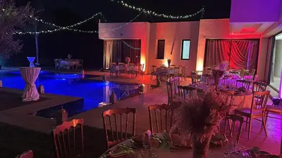 a banquet hall with tables and chairs and a pool at bianca in Marrakech